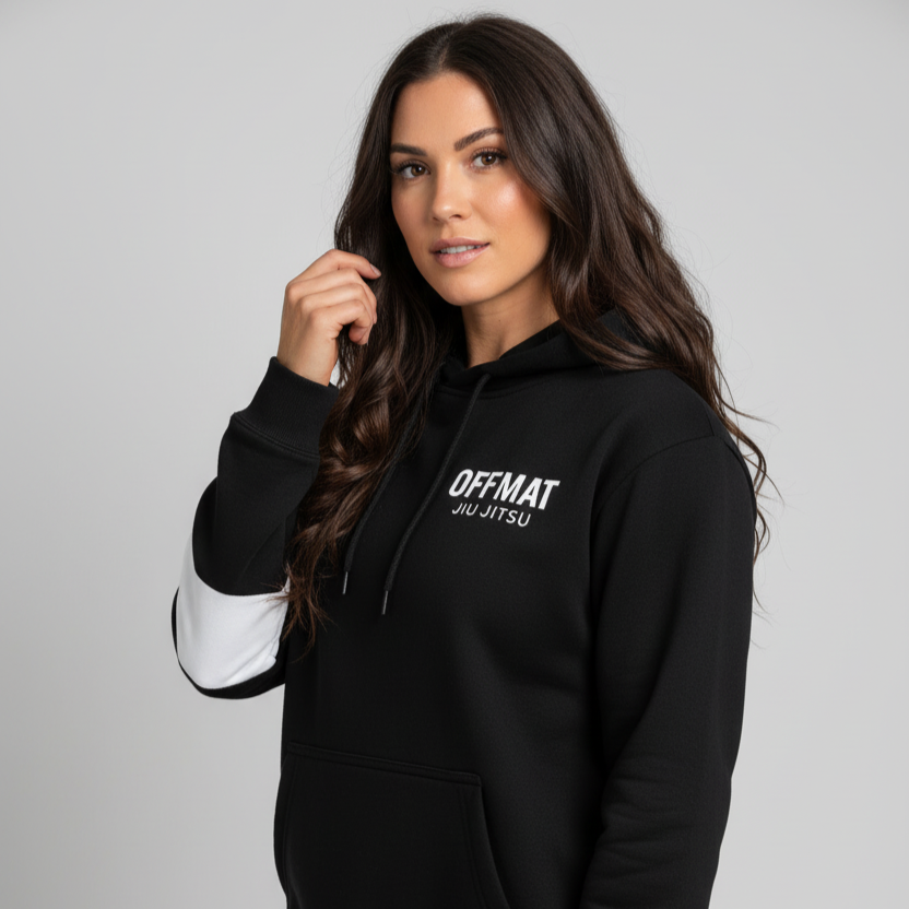 Woman wearing a black hoodie with 'OFFMAT' branding on a gray background